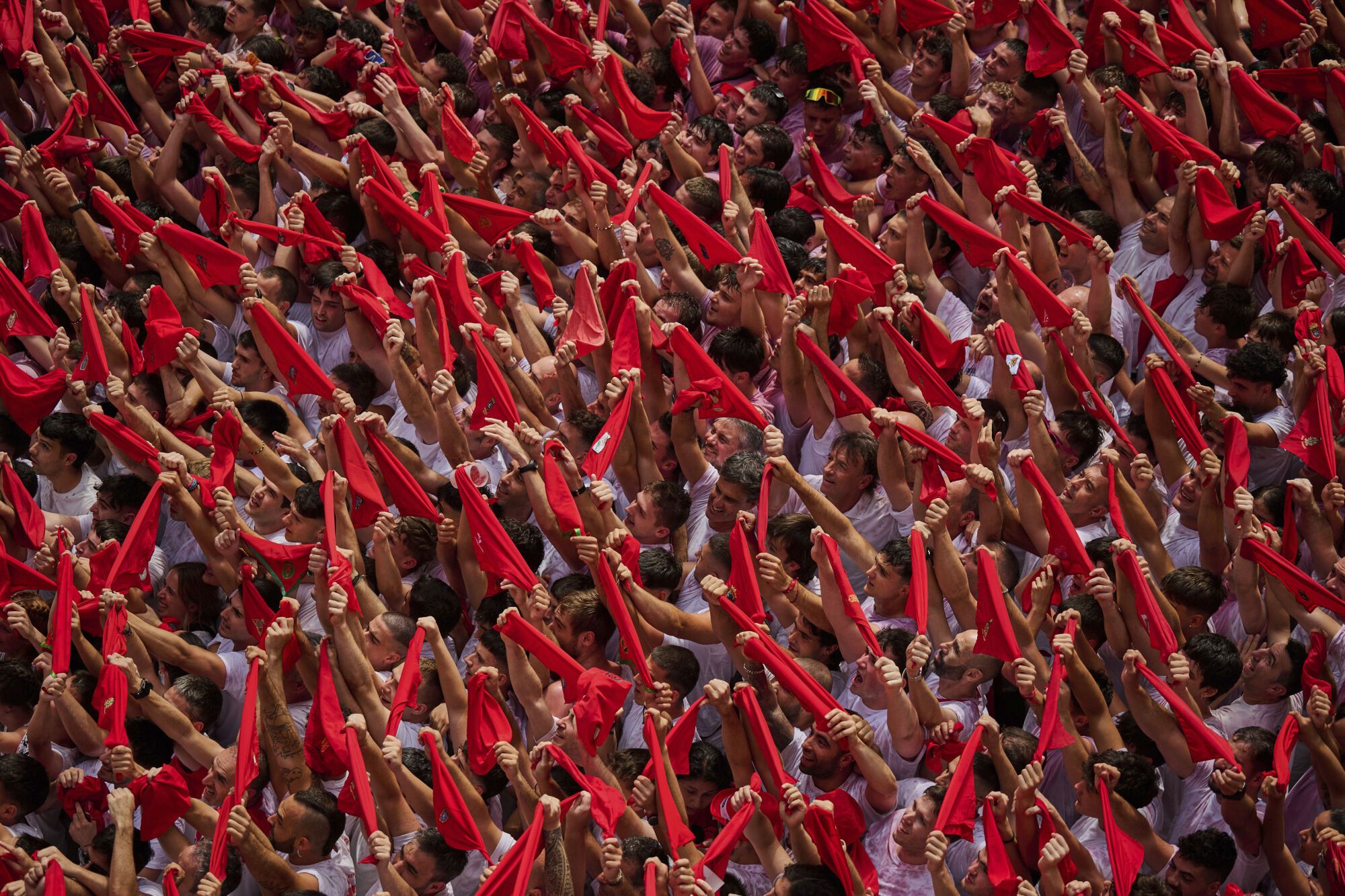 Revelers pack the main square during the start of nine days of uninterrupted partying in Pamplona's famed running-of-the-bulls festival in Pamplona, Spain, Sunday, July 6, 2025. (AP Photo/Miguel Oses). EDITORIAL USE ONLY/ONLY ITALY AND SPAIN