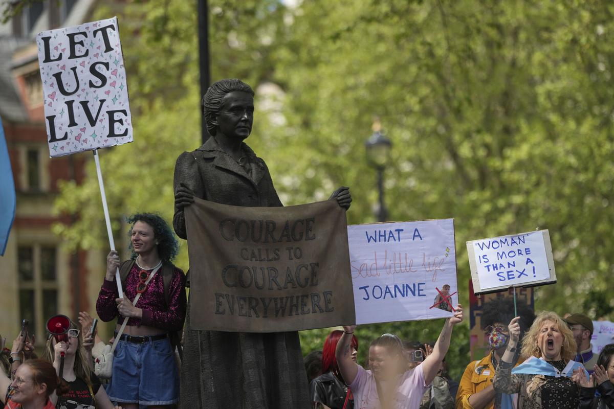 Campaigners take part in a rally organised by trans rights groups, trade unions, and community organisations following the Supreme Court ruling on the definition of a woman in equalities law, at Parliament Square, central London, Saturday April 19, 2025. (AP Photo/Alastair Grant)