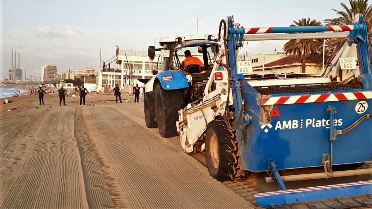 Equipo de limpieza del AMB por Sant Joan en una playa de Badalona.
