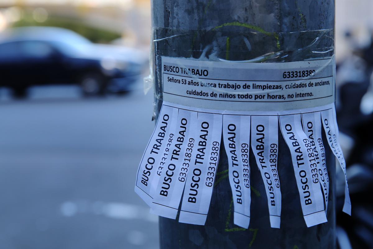 Papeles con anuncios enganchados en una farola, en una calle de Horta-Guinardó.