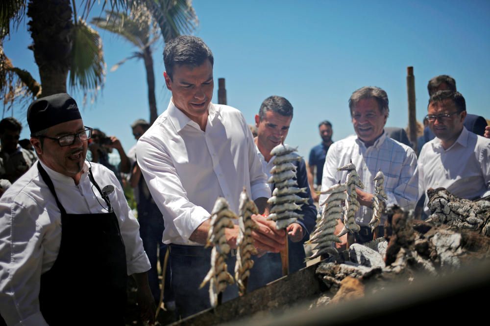 PSOE leader Sanchez puts sardines on a grill at ...