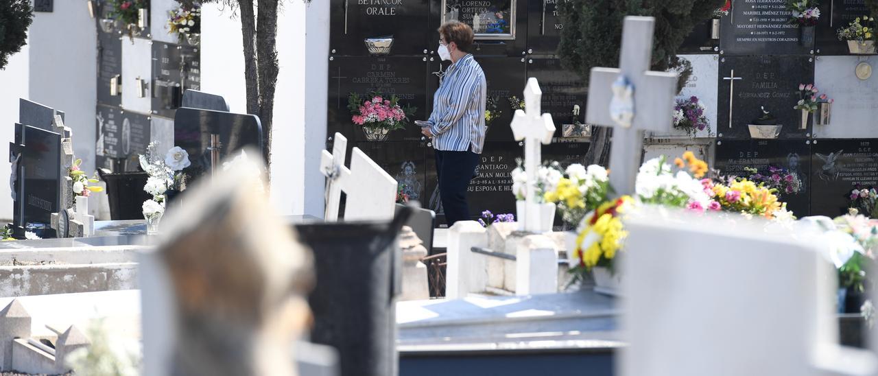 Una mujer visita los nichos en Cementerio de San Lázaro.