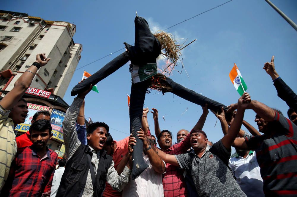 People burn an effigy depicting Pakistan as they ...