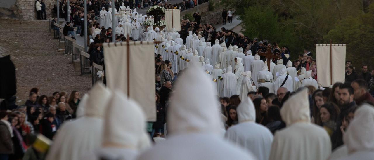 Las túnicas blancas bajan hacia el río camino del cementerio, ante la atenta mirada de los zamoranos, que salieron a ver el desfile de Luz y Vida. | Ana Burrieza