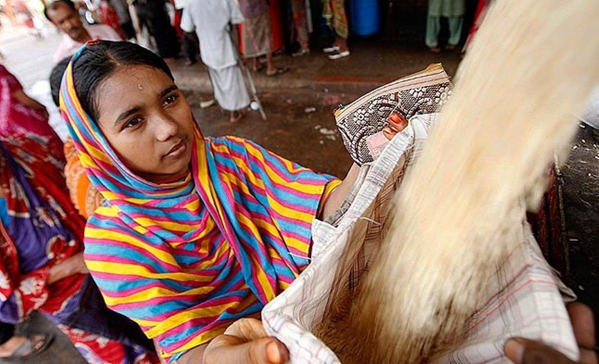 Una dona de Bangla Desh compra arròs aquest divendres en un mercat subvencionat de Dhaka. El Ministeri de Finances de Bangla Desh ha llançat una campanya per importar cereals amb l’objectiu d’assegurar el subministrament d’aliments.