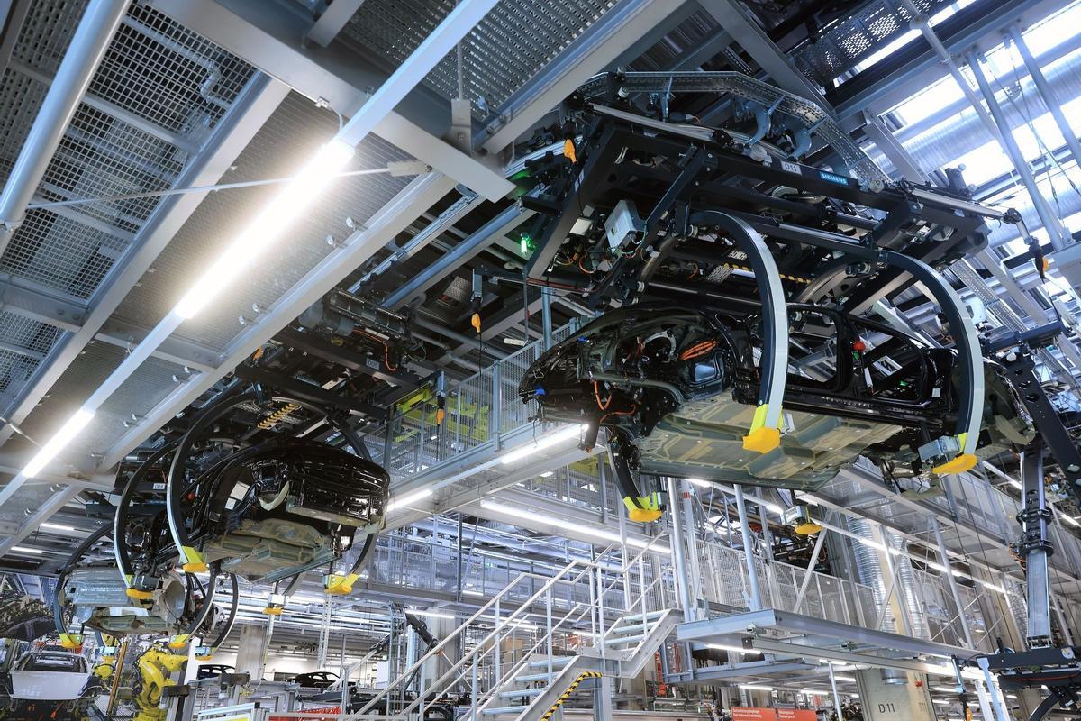 Los empleados trabajan en las carrocerías de los automóviles de lujo Porsche Taycan totalmente eléctricos en la línea de producción de la fábrica de Porsche AG en Stuttgart, Alemania.