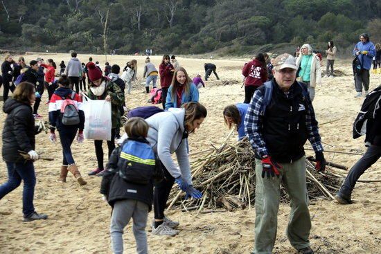 Un centenar de voluntaris recullen deixalles i apilen canyes a les platges de Palamós després del temporal