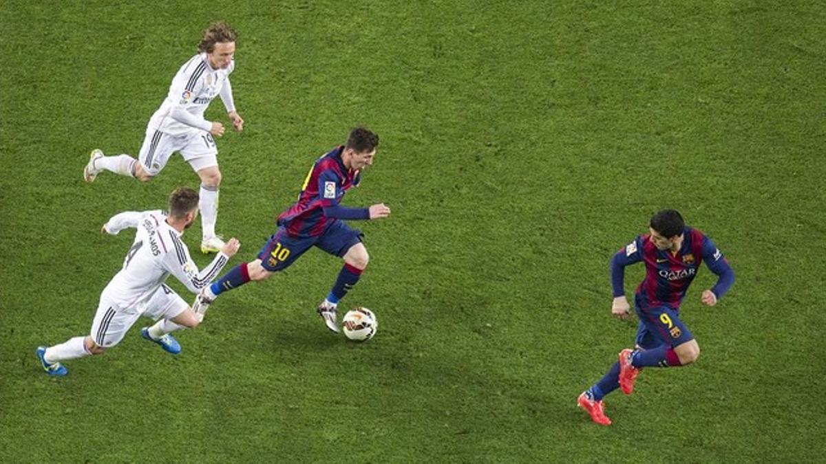 Messi, perseguido por Modric y Ramos, se interna hacia el centro del ataque azulgrana, ocupado por Suárez, durante el cásico liguero del Camp Nou.