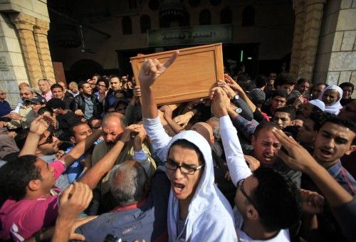 People carry the coffin of Mohamed Reda during his funeral service at Al Sayyida Nafisa mosque in Cairo
