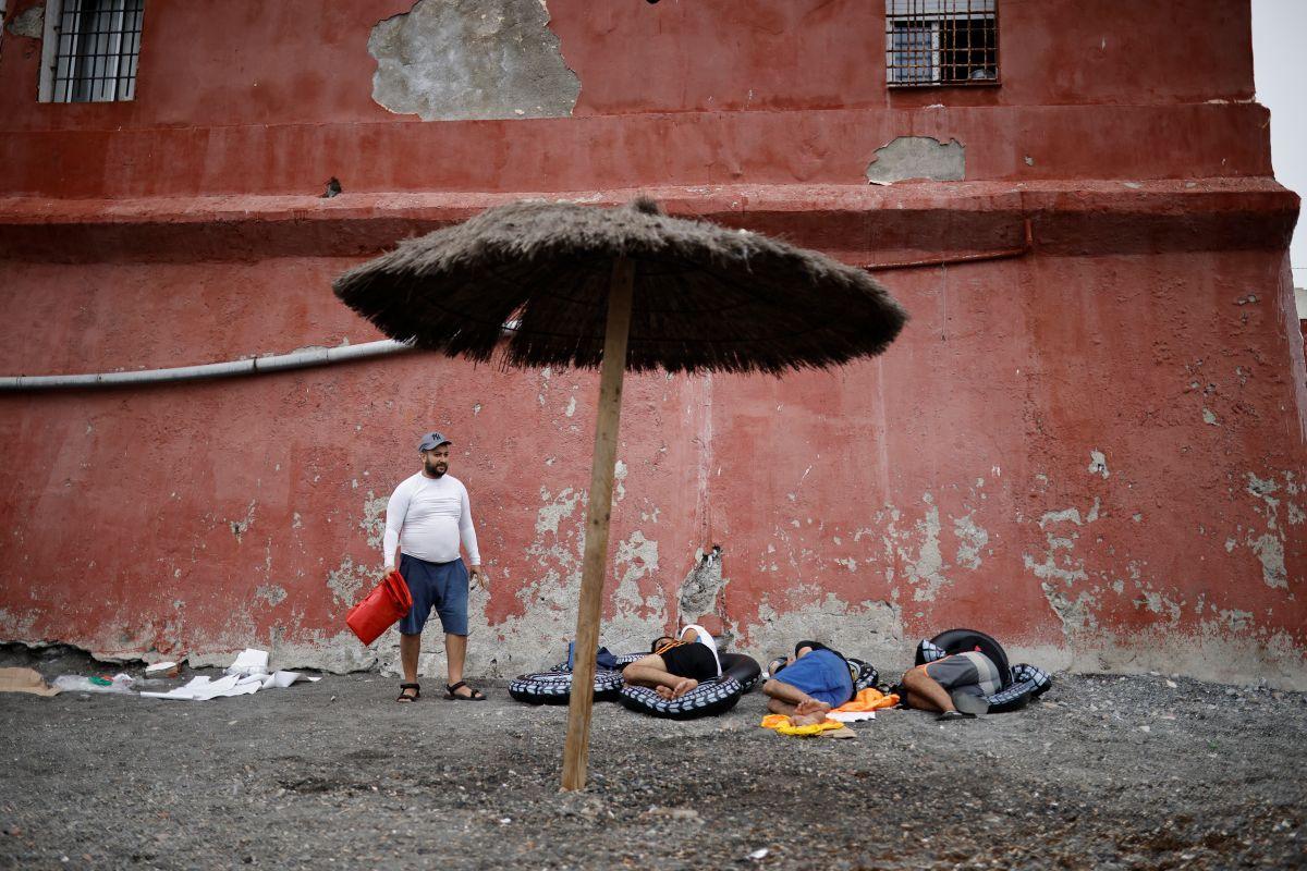 Migranten ruhen sich an einem Strand in Ceuta aus.