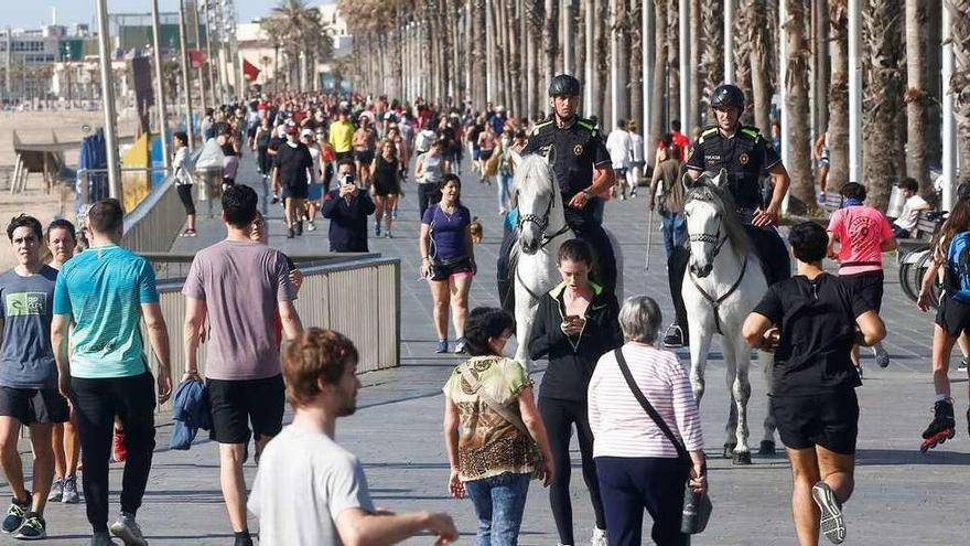 Dos policías a caballo patrullan en Barcelona el segundo día de autorización para pasear y hacer deporte. // Quique García
