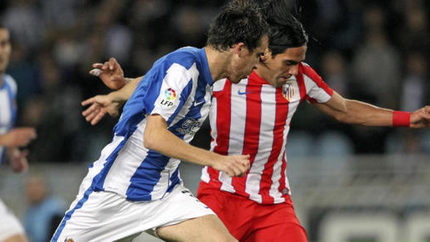 Falcao conduce el balón presionado por el centrocampista de la Real Sociedad Gorka Elustondo.