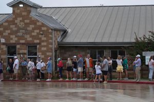 Families line up at a reunification center after flash flooding it the area, Friday, July 4, 2025, in Ingram, Texas. (AP Photo/Eric Gay)
