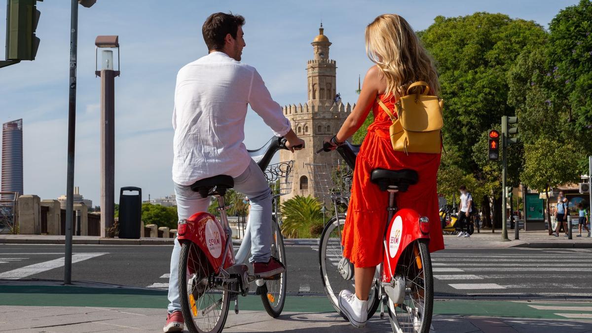 Un hombre y una mujer pasean por Sevilla en Sevici.