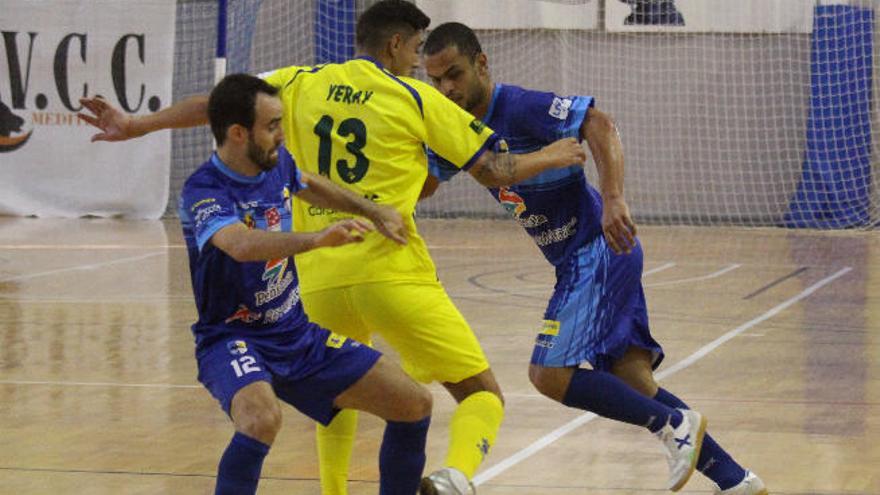 Yeray, autor de los goles del Gran Canaria, presionado por dos rivales.