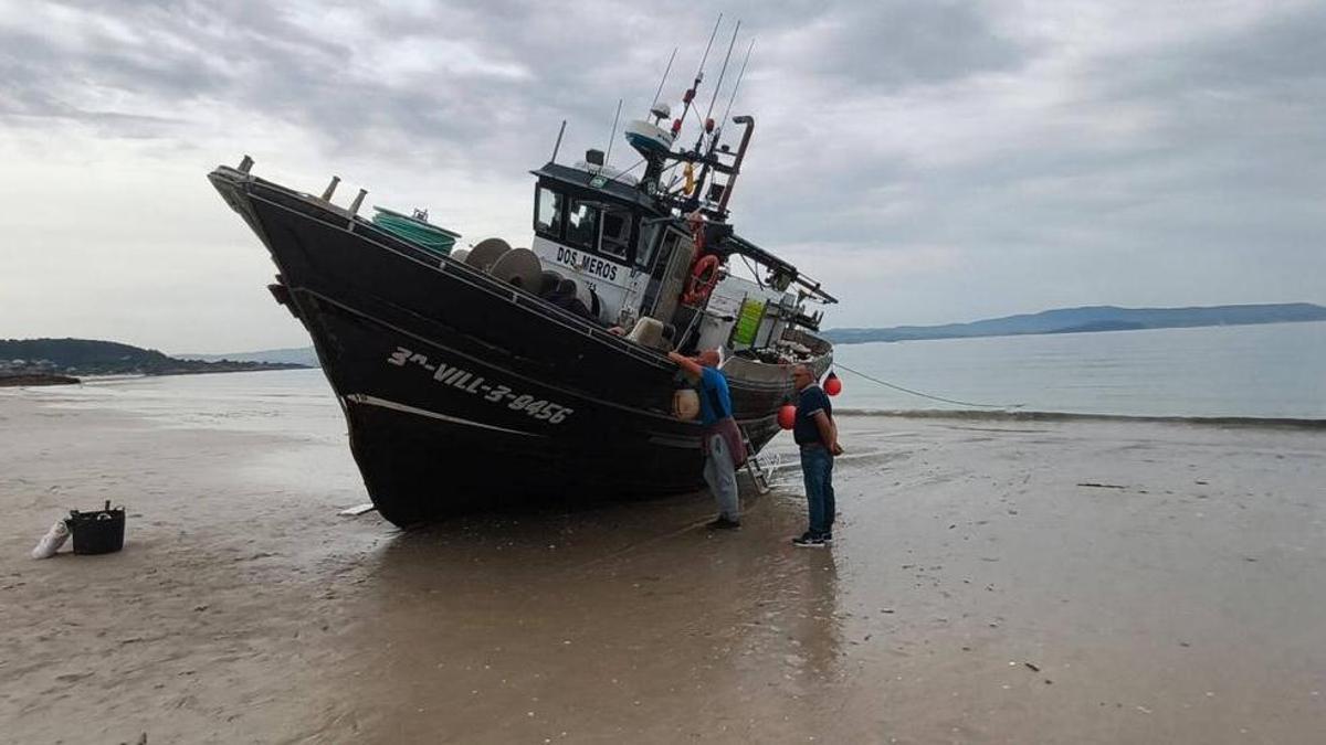 El barco "Dos Meros" varado en la playa de Barra