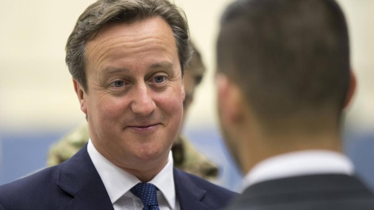 Britain's Prime Minister David Cameron speaks to an RAF apprentice as he views a newly delivered A400M Atlas aircraft at RAF Brize Norton, central England