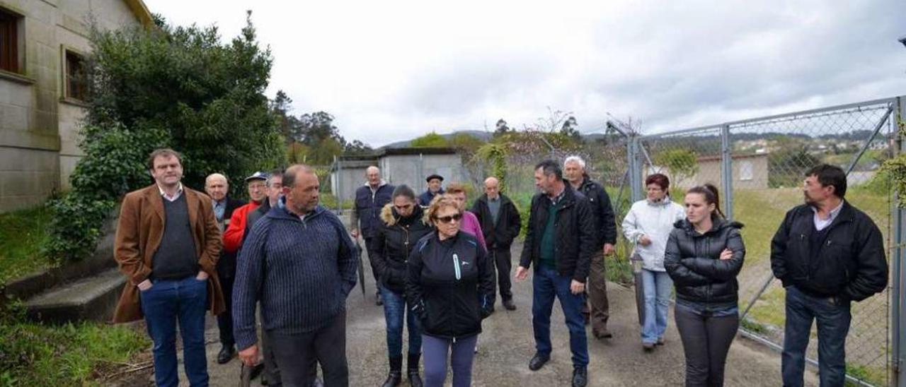 Abraldes y Sanmartín con los vecinos afectados delante de la captación de San Amaro. // Gustavo Santos