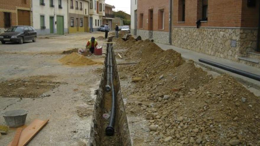 Trabajos de renovación de la red de agua en la calle La Bañeza de San Cristóbal de Entreviñas, en la mañana de ayer.