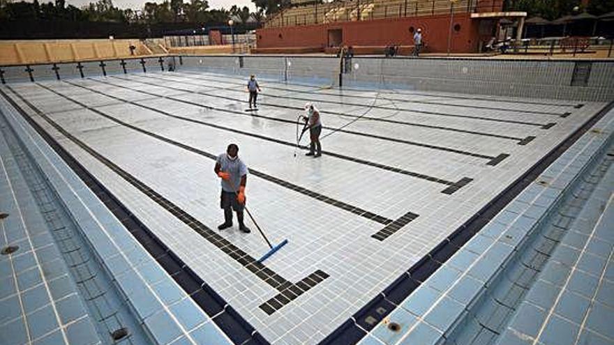 Operarios de Deportes trabajan en la piscina municipal Murcia Parque.