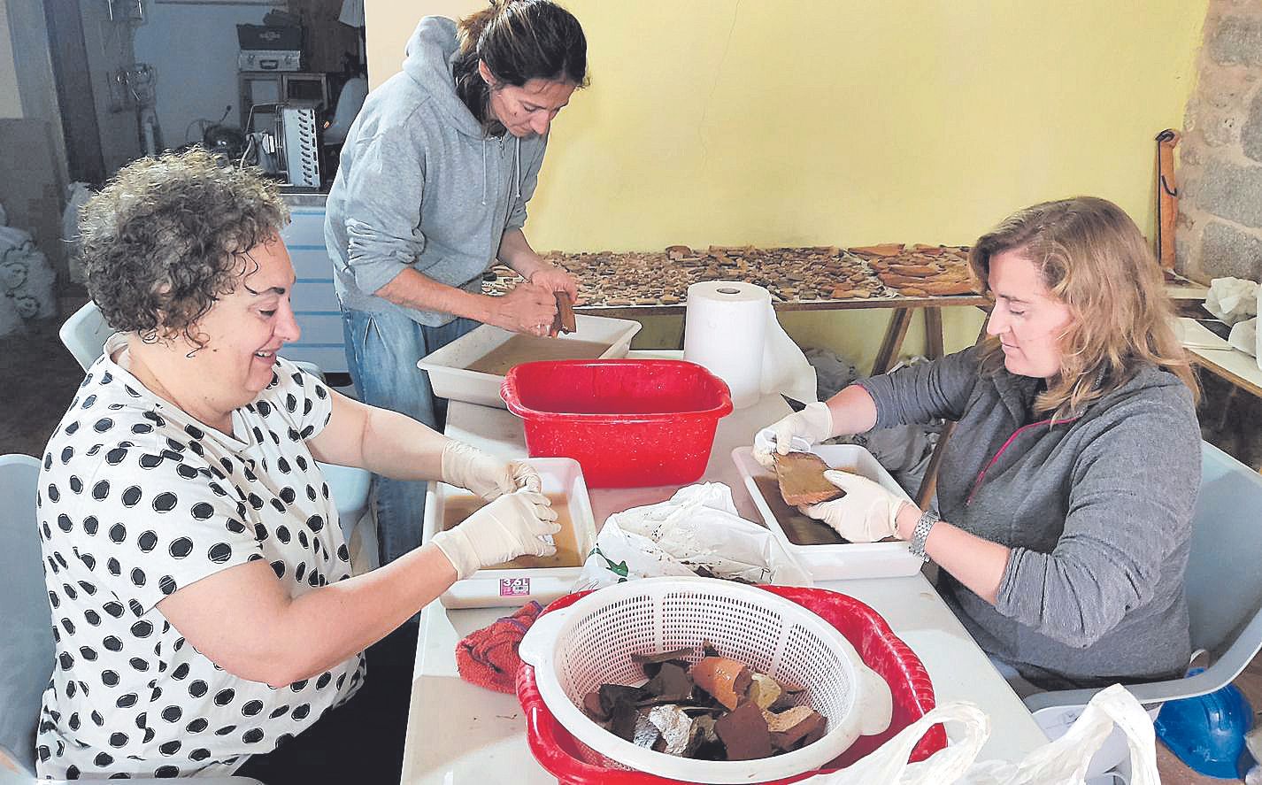 Las arqueólogas Magdalena Sastre (centro) y Cristina Rubio (derecha) junto a la voluntaria Monse, durante las tareas de limpieza.