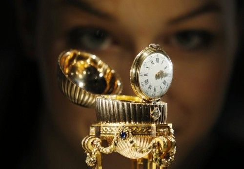 An assistant poses for a photograph with a Faberge egg during a photo-call at  antique dealer Wartski, in central London