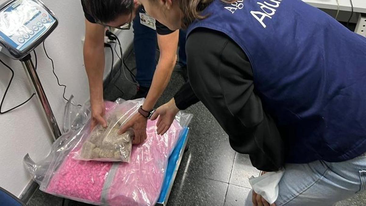 Agentes de Vigilancia Aduanera y Guardia Civil durante el pesado de la droga en el aeropuerto.