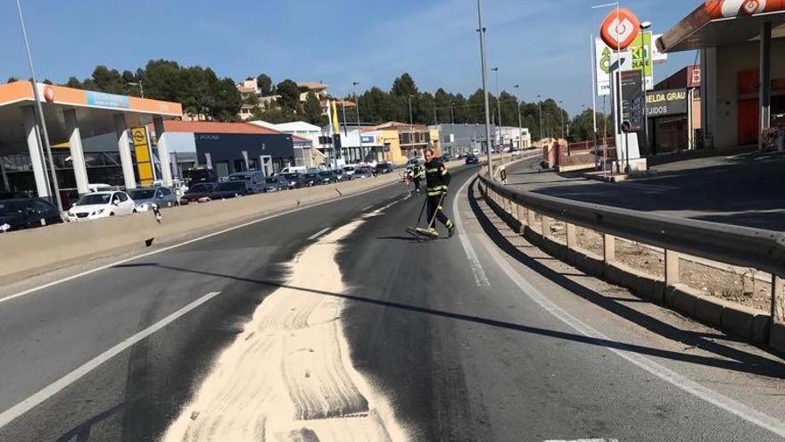 Los bomberos esparcen sepiolita por la vía para empapar el combustible vertido.