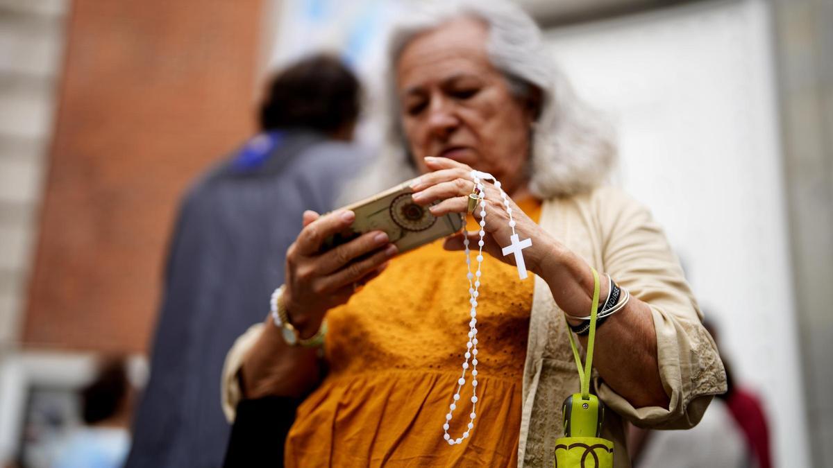 Una mujer preparada para rezar el rosario en la calle Ferraz de Madrid.