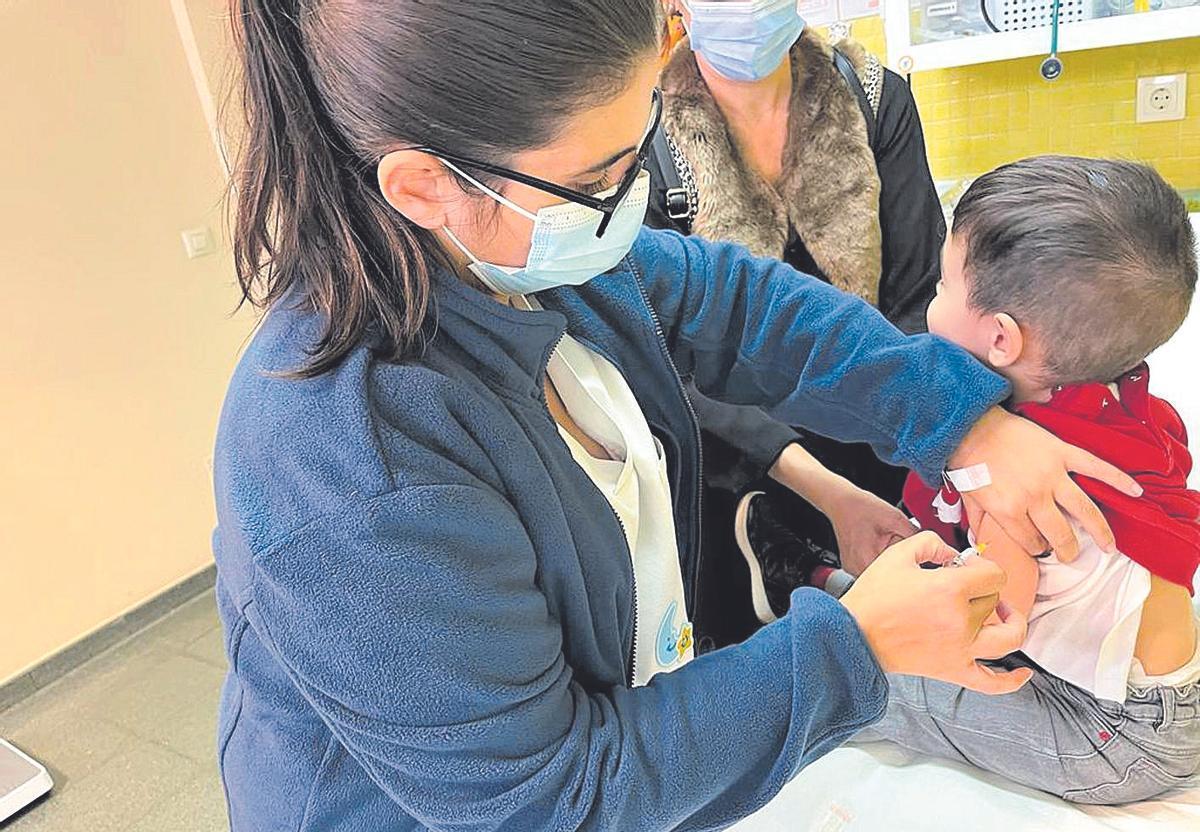 Una enfermera inocula la vacuna antigripal a un menor de 5 años en un centro médico de A Coruña