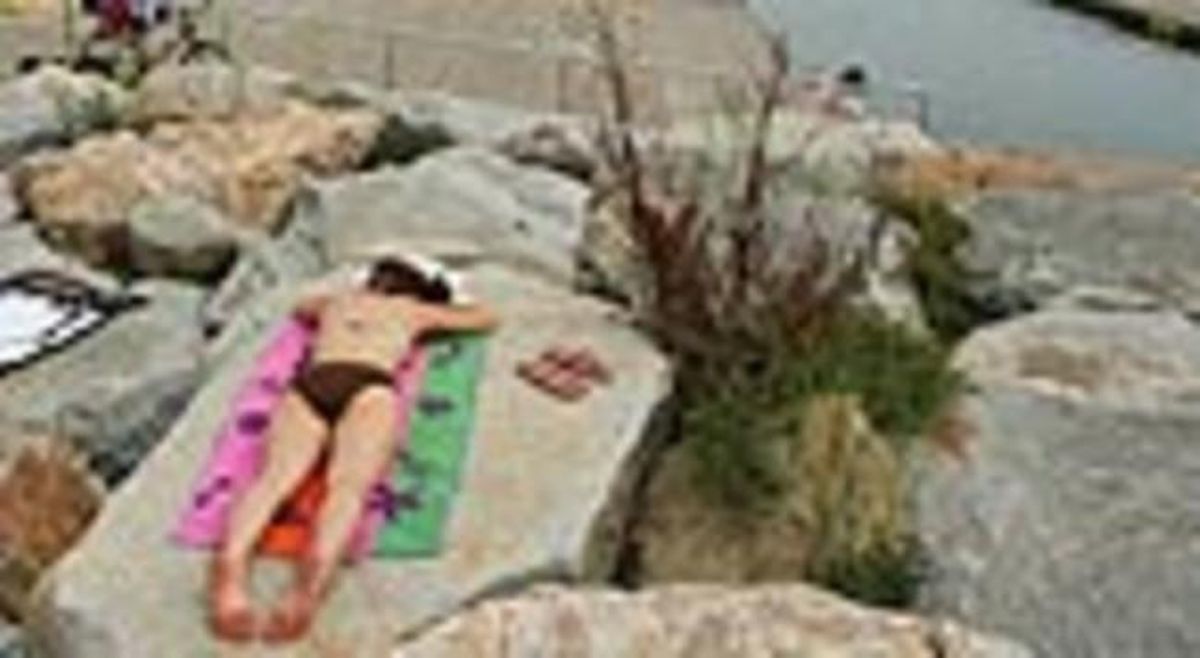 Una dona descansa a la platja del Fòrum.