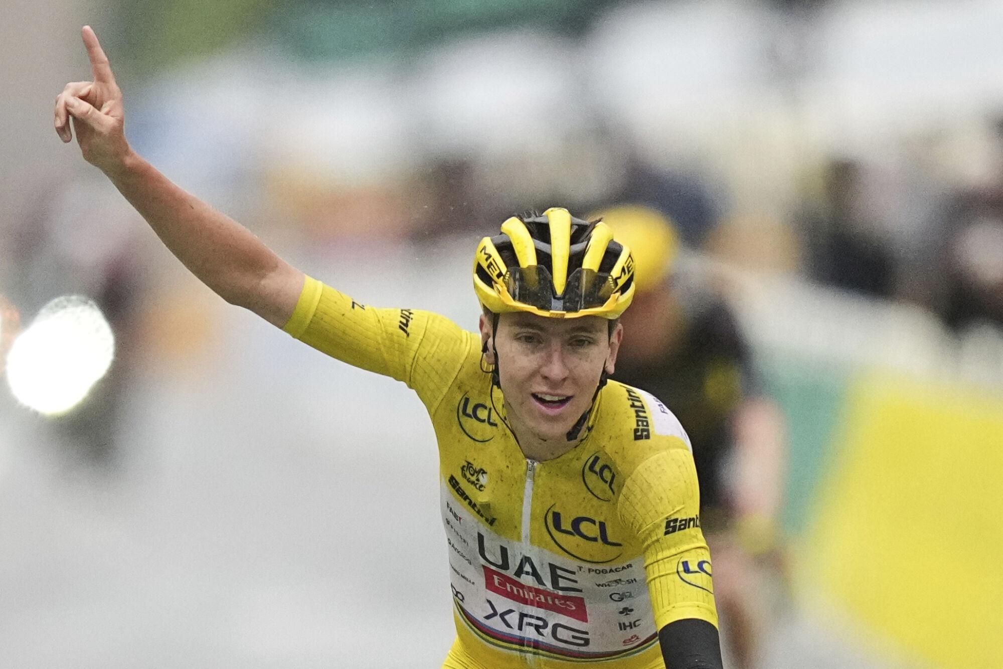 Tour de France winner Tadej Pogacar of Slovenia crosses the finish line of the twenty-first stage of the Tour de France cycling race over 132.3 kilometers (82.1 miles) with start in Mantes-la-Ville and finish on the Champs-Elysees in Paris, France, Sunday, July 27, 2025. (AP Photo/Thibault Camus)
