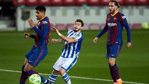 Araujo pelea con Portu ante la mirada de Mingueza en el Barça-Real Sociedad del Camp Nou.