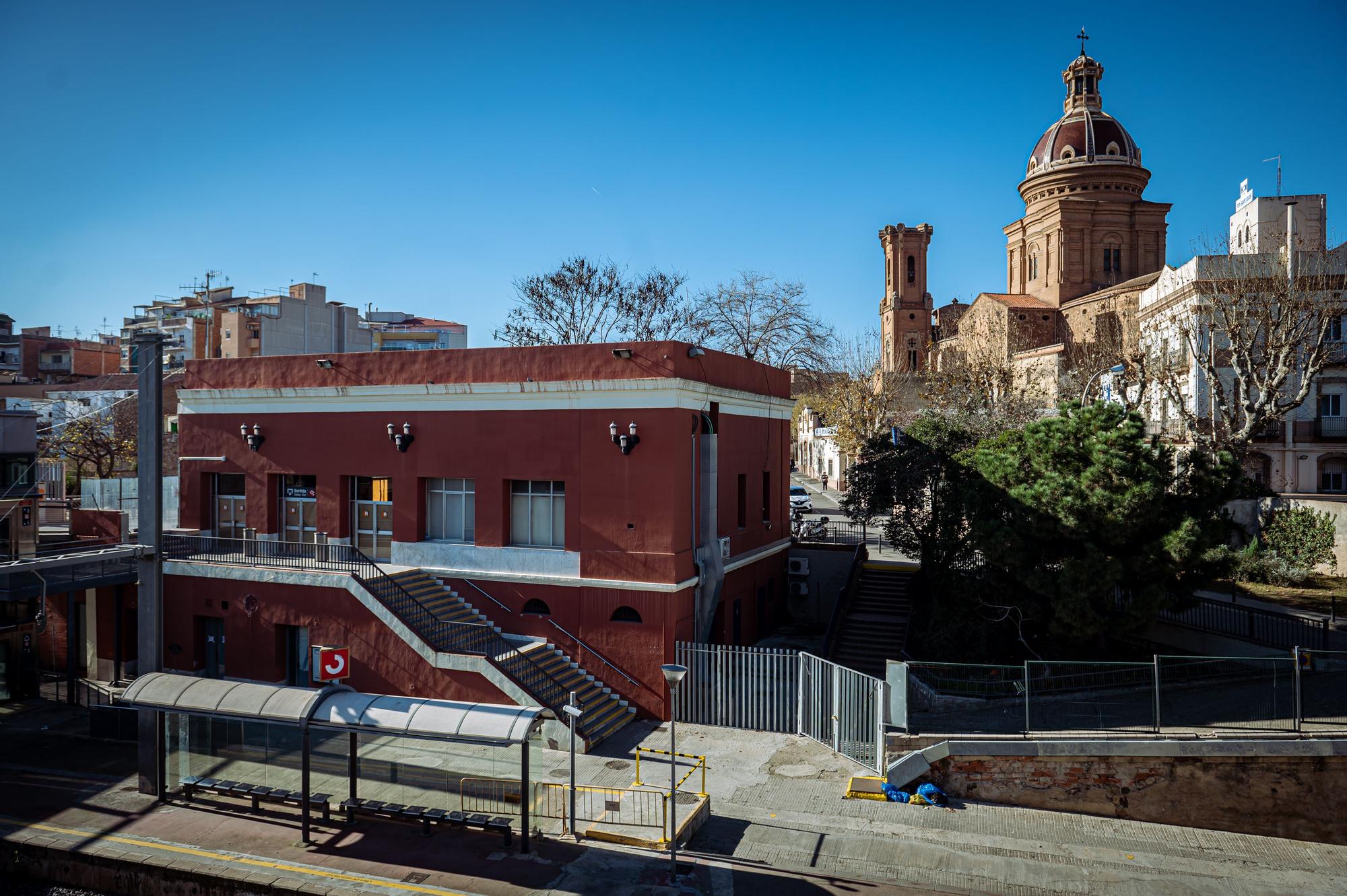 La clausurada estación de Sant Andreu Comtal, con la cúpula de la parroquia y la clínica Sant Jordi detrás