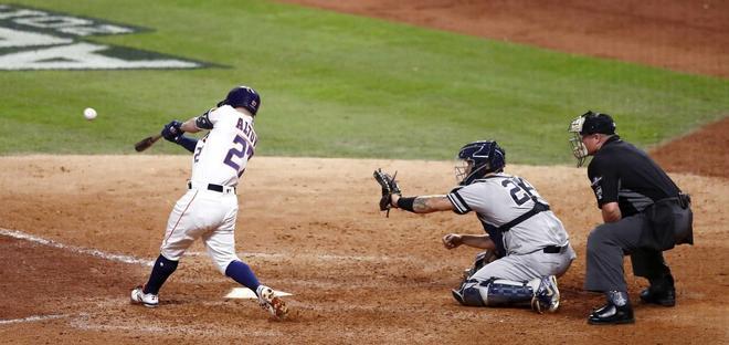 José Altuve (L) de los Astros bateó un jonrón ganador de la serie al final de la novena entrada del juego de playoffs de la Serie del Campeonato de la Liga Americana de Béisbol de las Grandes Ligas en el Minute Maid Park en Houston, Texas, EE. UU..