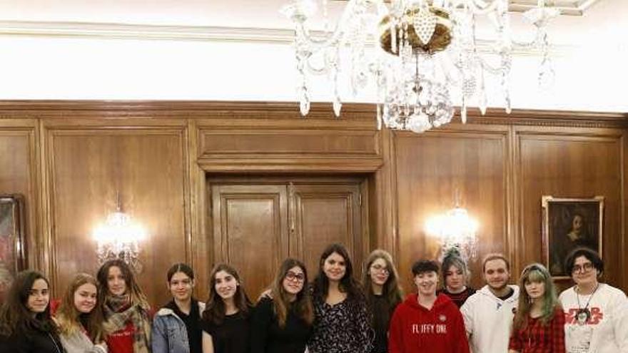 Raquel Ruiz, en el centro, con los estudiantes que participan en el proyecto Antenas Informativas, en el salón de recepciones del Ayuntamiento.