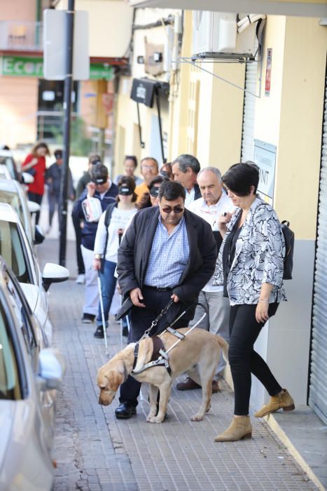 Algunas personas, entre ellos políticos, comprueban las dificultades de moverse por la calle que sufren las personas con discapacidad visual.