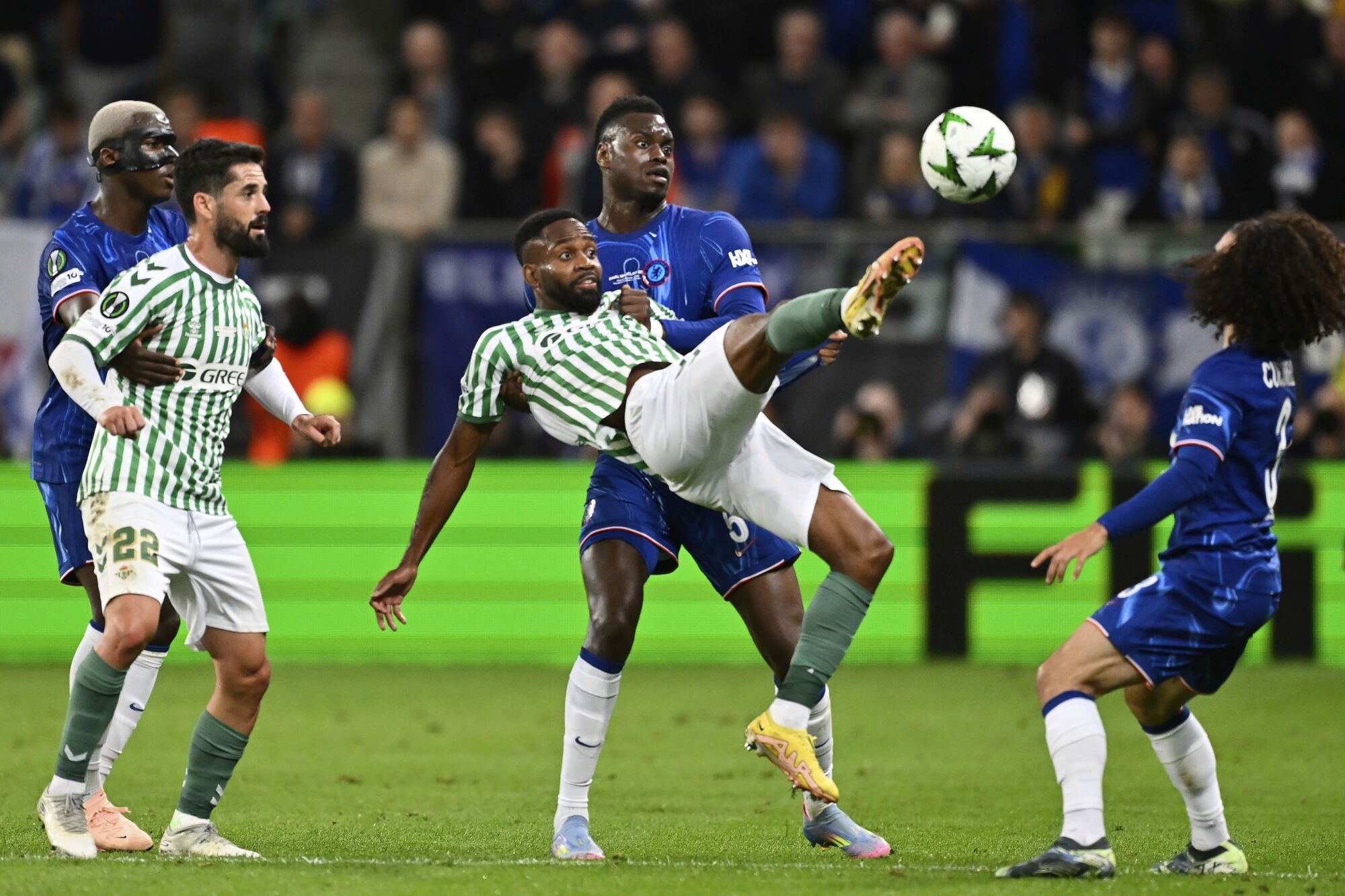 Betis' Cedric Bakambu jumps for the ball during the Europa Conference League final soccer match between Real Betis and Chelsea in Wroclaw, Poland, Wednesday, May 28, 2025. (AP Photo/Denes Erdos)