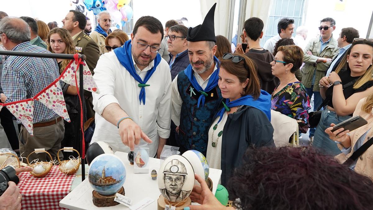 Por la izquierda, Adrián Barbón, Ángel García y Adriana Lastra, este martes, paseando entre los puestos de güevos pintos.