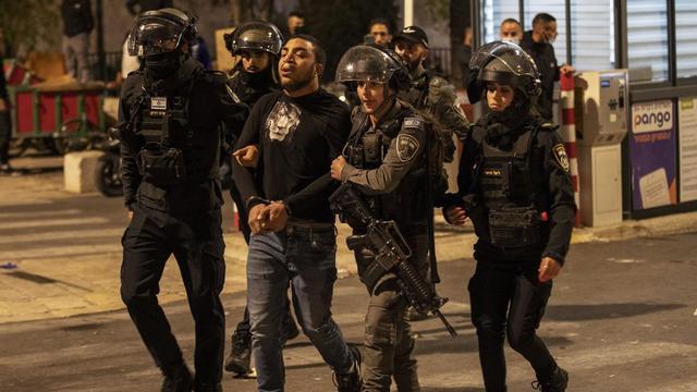 Agentes israelís llevan a un detenido palestino.