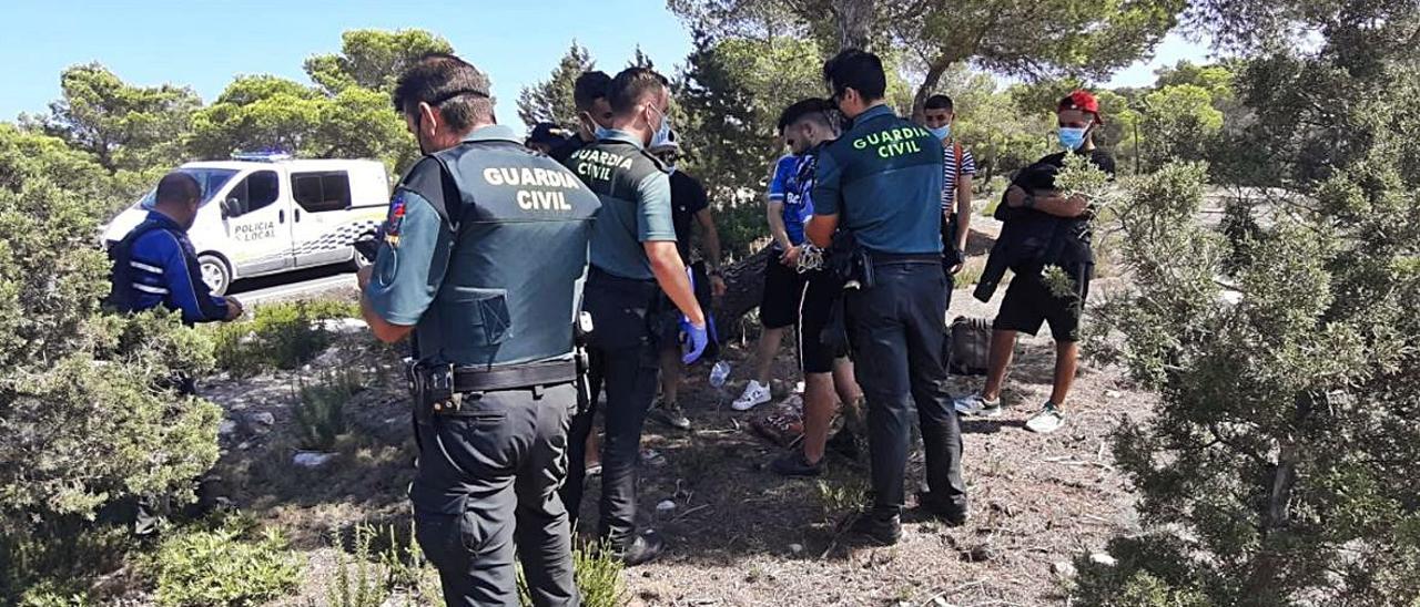 La Guardia Civil y la Policía Local atienden a los migrantes junto a la carretera de subida a la Mola
