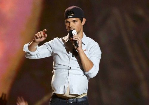 Actor Taylor Lautner accepts the award for best shirtless performance at the 2013 MTV Movie Awards in Culver City, California