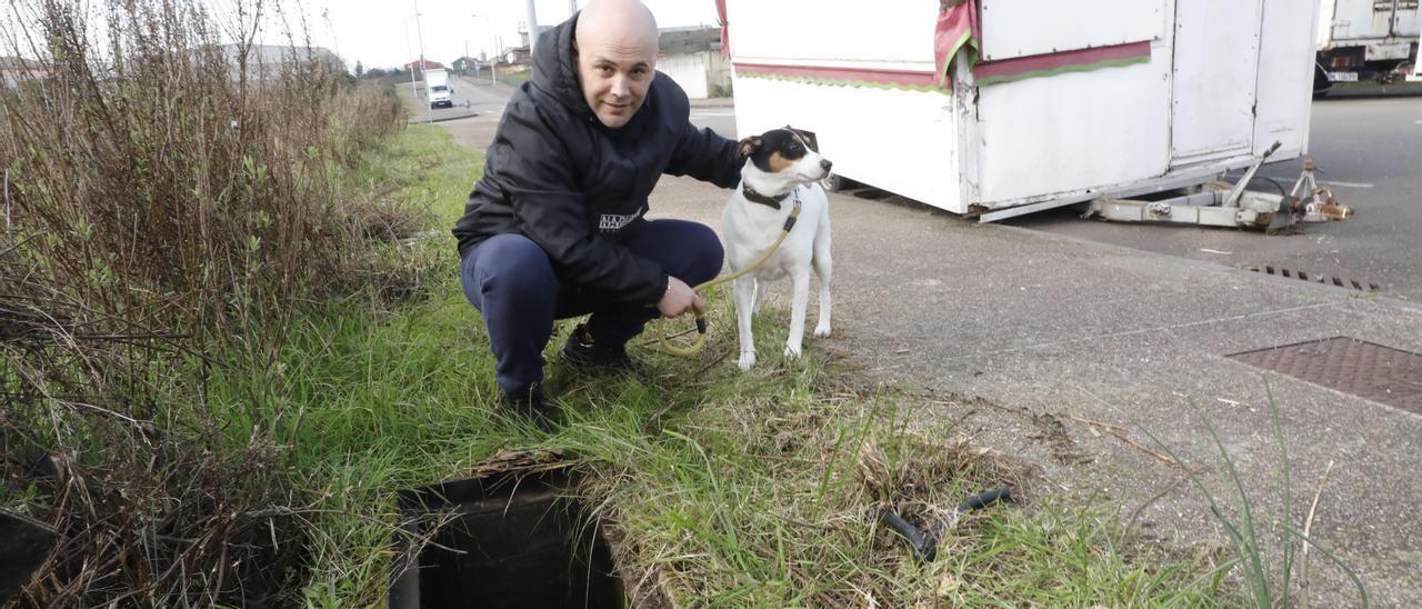 Jesús Fernández señala la alcantarilla a la que se precipitó su perro “Pancho” en la calle José Antonio Hevia Corte, en el polígono industrial de Lloreda.