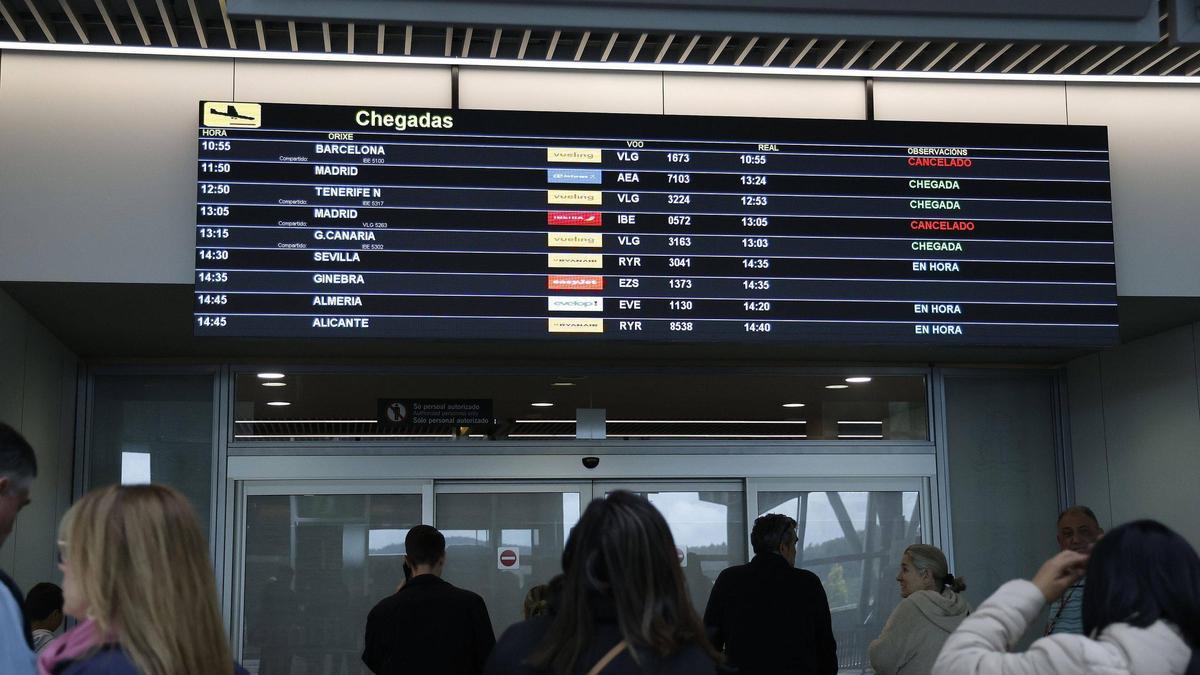 Panel de llegadas con vuelos cancelados en el aeropuerto de Santiago este viernes