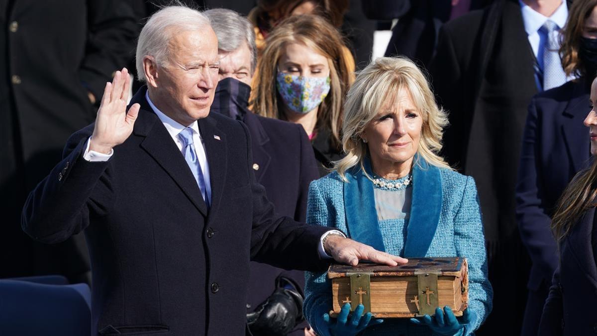 Joe Biden is sworn in as the 46th President of the United States as his wife Jill Biden holds a bible on the West Front of the U S  Capitol in Washington  U S   January 20  2021  REUTERS Kevin Lamarque