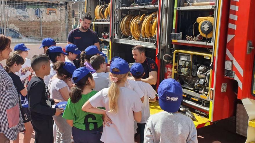 Alumnos del CEIP José Moreno de Murcia atienden las explicaciones de los miembros del cuerpo de bomberos en las instalaciones del centro. | L.O.