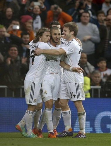 Real Madrid's Benzema celebrates his goal against Celta Vigo with teammates Illarramendi and Modric during their Spanish First Division soccer match at Santiago Bernabeu stadium in Madrid