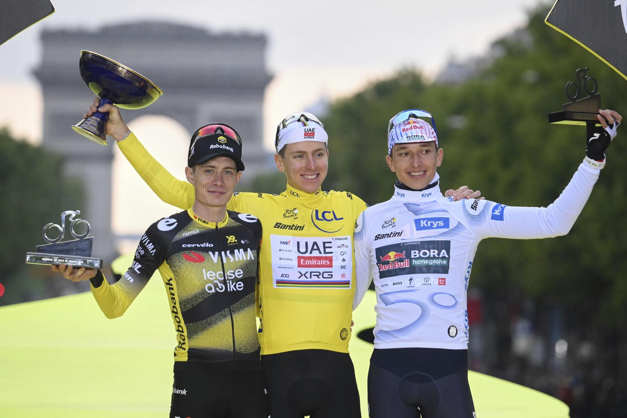 Denmark&#039;s Jonas Vingegaard, second placed, Slovenia&#039;s Tadej Pogacar, the Tour de France winner, and Germany&#039;s Florian Lipowitz, third placed, from left, celebrate during the presentation ceremony for the Tour de France on the Champs-Elysees in Paris, France, Sunday, July 27, 2025. (Bernard Papon, Pool Photo via AP). POOL PHOTO