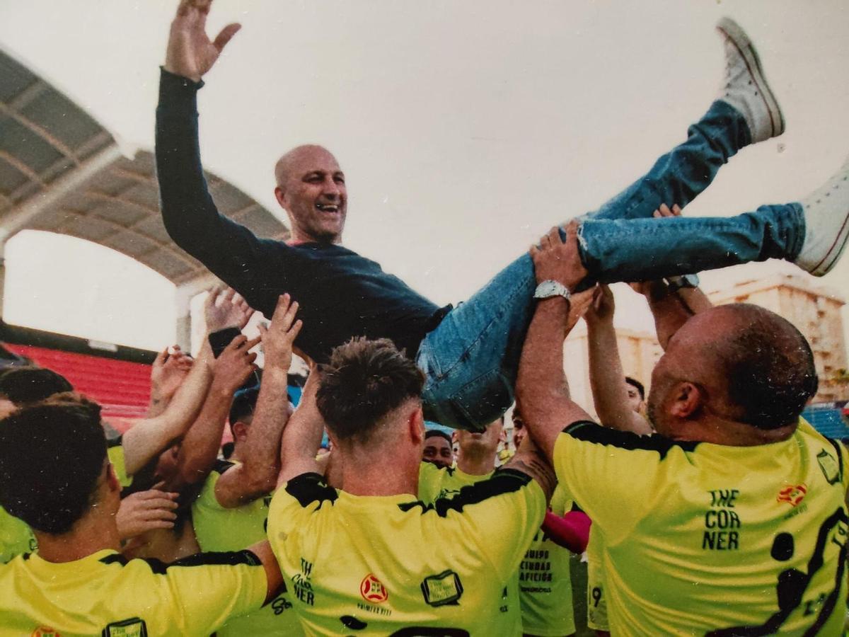 Chus Trujillo es manteado por los jugadores del Ceuta tras conseguir el ascenso a Primera RFEF en 2022.