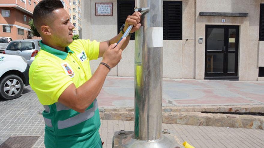 El operario Maikel Santana es el encargado de limpiar las 4.000 farolas de la campaña